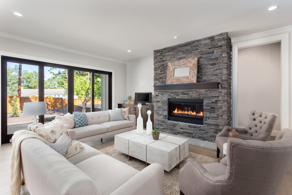 Beautiful living room interior with hardwood floors and fireplace in new luxury home.